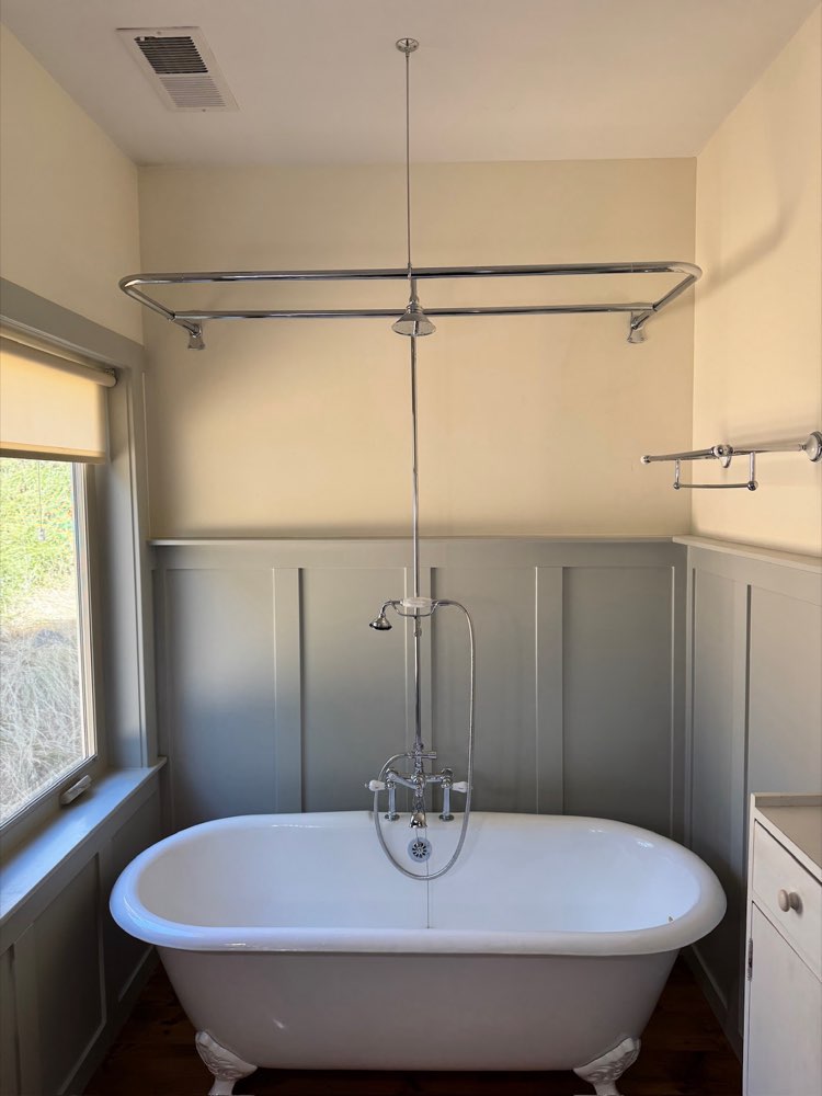 Clawfoot tub with exposed shower riser