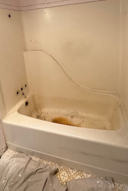 Before: old stained tub-shower